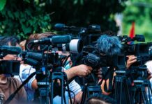 Malibu Sinkhole Threatens Million-Dollar Homes TV news cameras crowding together at an outdoor event