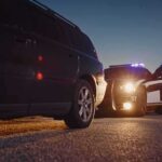 4 Juveniles Arrested in 77-Case Bay Area Burglary Spree Police officer at patrol car during traffic stop at dusk