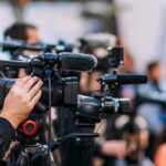 Deadly Plane Crash in San Diego Video cameras on tripods at a media event