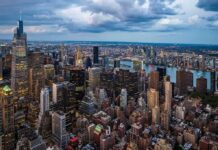 Gen Z Bolt: New York-to-Philly Migration Grows City skyline at dusk with river and dense skyscrapers
