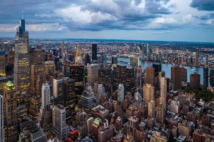 shutterstock_2288688135-1 City skyline at dusk with river and dense skyscrapers