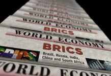 BRICS Warning Jolts Oil Markets Stack of newspapers highlighting BRICS and world economy