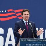 Ron DeSantis speaking at a podium with a microphone