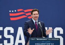 DeSantis Warns $5,000 Checks Could Fuel Inflation Ron DeSantis speaking at a podium with a microphone