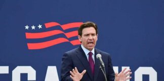 Ron DeSantis speaking at a podium with a microphone
