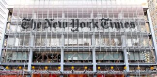 The New York Times building facade with street traffic