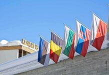 New Greenland Security Pact Signed Row of national flags on a snowy building facade
