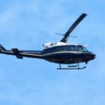 Helicopter flying against a blue sky