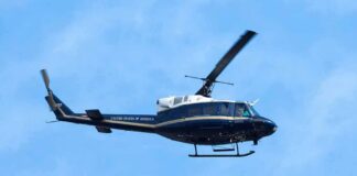 Helicopter flying against a blue sky