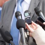 Congressman Faces Abuse Allegations Fight Microphones held toward a person in a suit