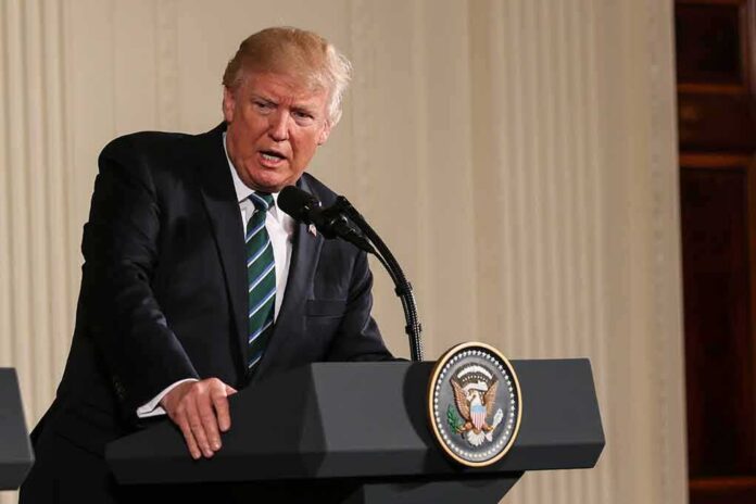 Donald Trump speaking at a podium with presidential seal