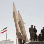 Iran Threat: Every U.S. Base On Notice Soldiers stand beside large missiles at an outdoor display