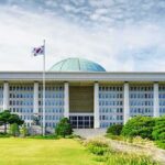 Iran Warns South Korea Over Hormuz Mission Parliament building with a green dome and flagpoles