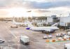Pilot Attacked Captain Mid-Flight Airplanes at airport gates during sunset with ground vehicles and jet bridges