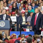 Rally Stunner: Trump Announces Medal of Freedom Ron DeSantis speaks at a rally as Donald Trump looks on; Badri Patarkatsishvili, Susie Blake, Grynet Molvig, and Martha Firestone Ford in crowd