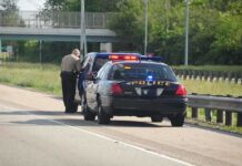 Man Accused of Attacking Federal Officers With Hammer Police officer conducting a traffic stop on a highway
