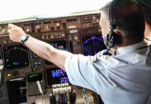 Investigators Examine Co-Pilot’s Online History Pilot adjusting controls in an airplane cockpit