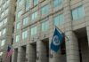 Viral Immigration Clip Ignites Due Process Fight U.S. government building facade with American and blue departmental flags