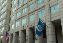 Viral Immigration Clip Ignites Due Process Fight U.S. government building facade with American and blue departmental flags