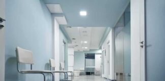 Empty medical clinic hallway with chairs
