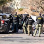 72-Year-Old Homeowner Faces No Charges After Shooting Police and sheriff officers gather around vehicles on a suburban street