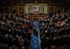 Election Rules Spark New Political Clash Legislative chamber audience stands and applauds
