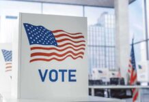 TV Warning Sparks Military Draft Fears Voting booth with American flag design in a modern polling place