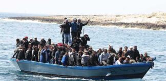 Crowded blue boat at sea with Ivan Morales Jr., Andreas Hestler, Isaiah Frey, Christian Jones, and Teddy Williams among passengers