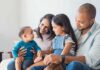 Brother Says Trump Politics Drove Siblings Apart Family sitting on couch with parents, daughter, and baby smiling together