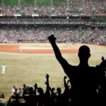 White Sox Stun Cleveland in Game 2 Crowd of fans cheering at a baseball game in a stadium